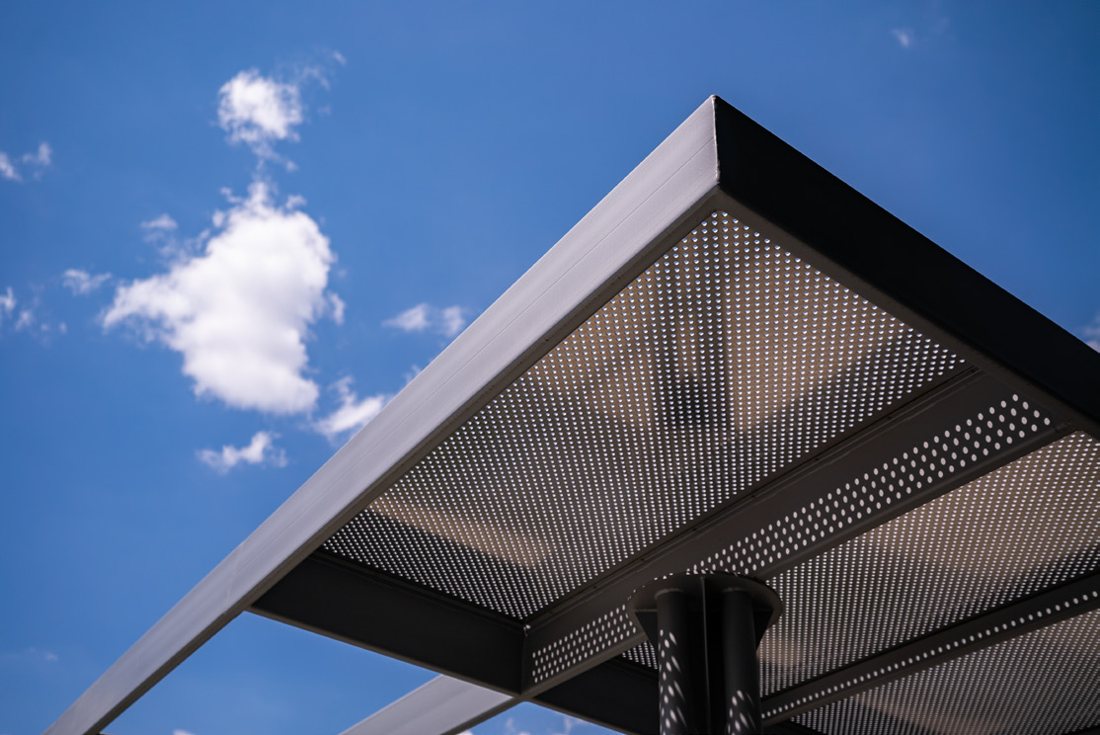 Aluminium and glass canopy against a blue sky