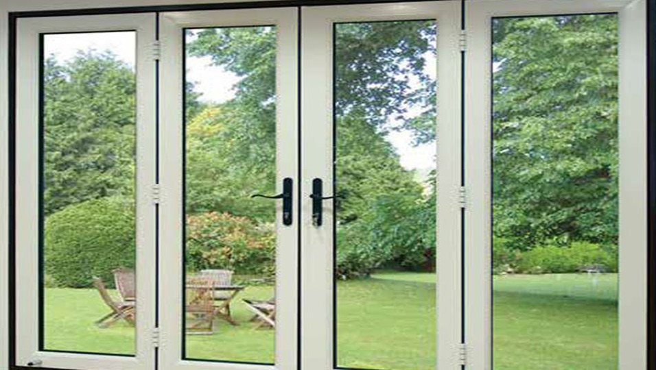 Hinged aluminium doors opening onto a garden